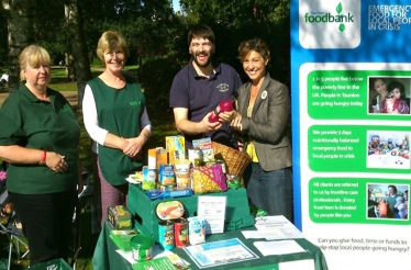 Prospective MP Rebecca Pow hands over a bottle of juice to Andy Sharman